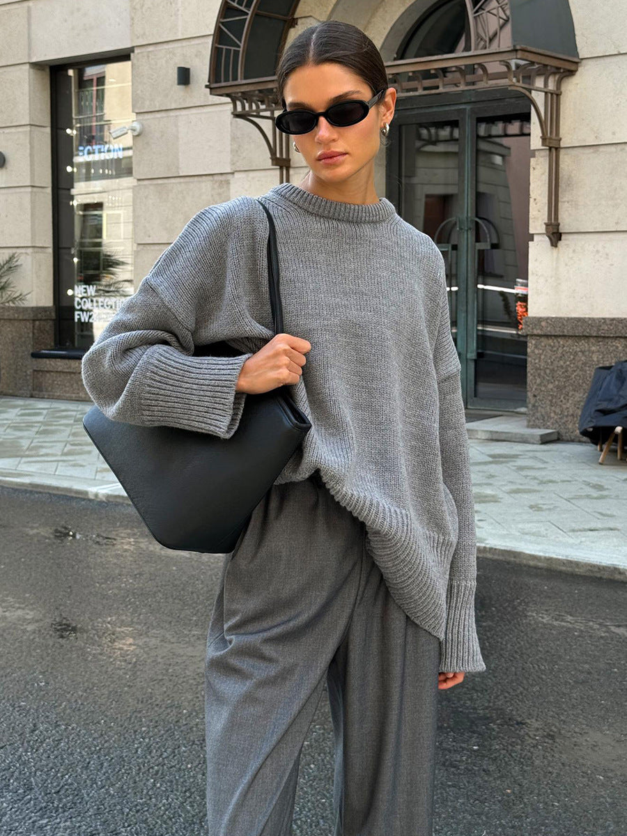 Grey round-neck knit sweater with long sleeves and ribbed hem and cuffs