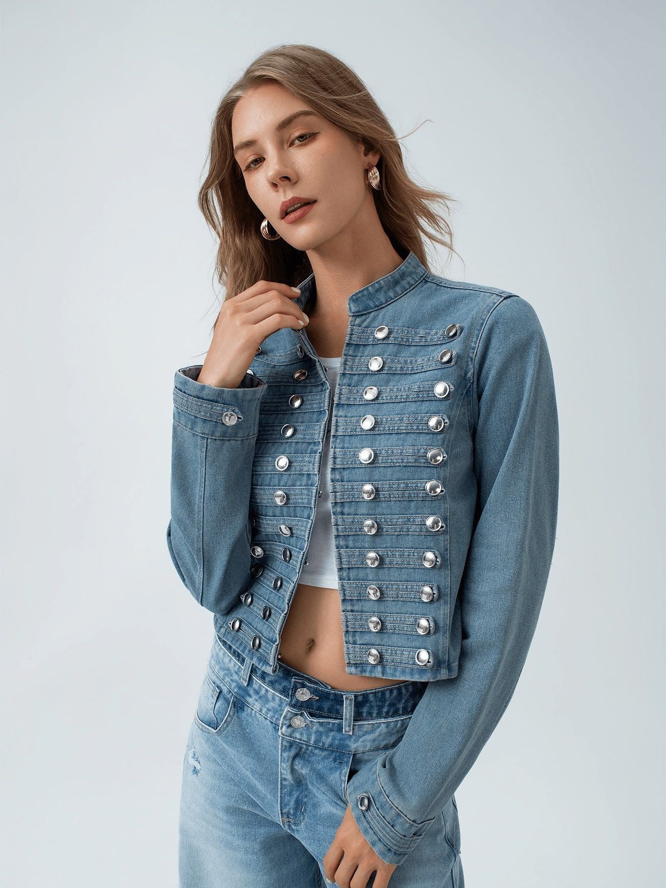 Women’s short light blue denim jacket with stand collar and double-breasted silver snap studs