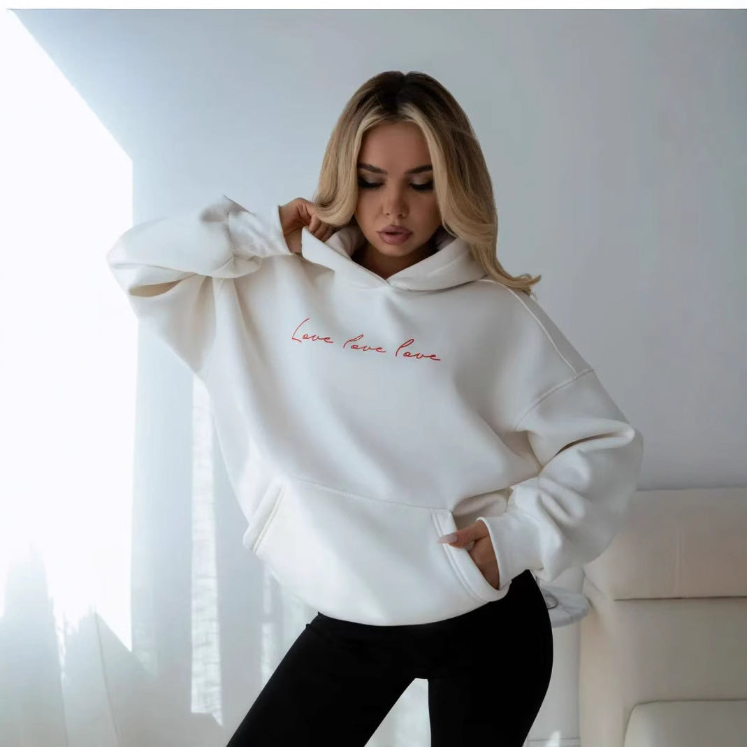 White hooded sweatshirt with red script "Love love love" and kangaroo pocket