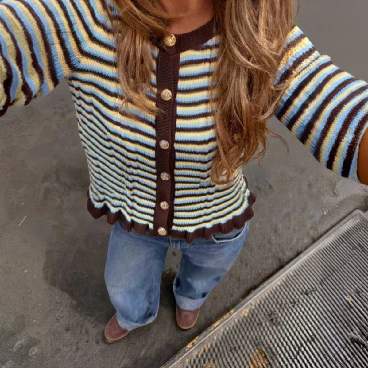 Striped ribbed cardigan with dark button-front, round neck; blue/cream stripes, lettuce hem.