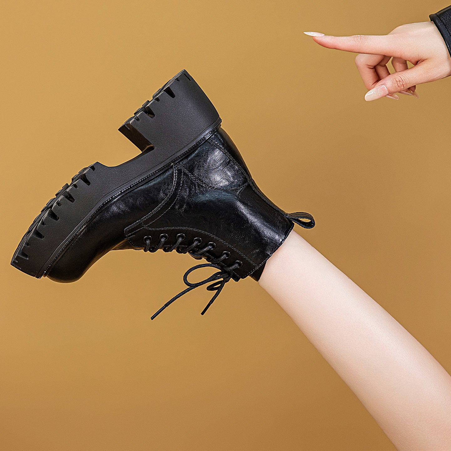 Black lace-up combat ankle boots with padded collar and chunky platform
