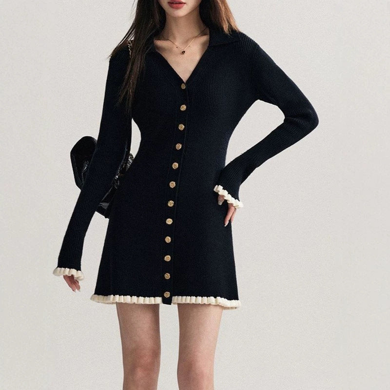 Black collared knit mini dress with long sleeves, ruffle cuffs, and gold button placket