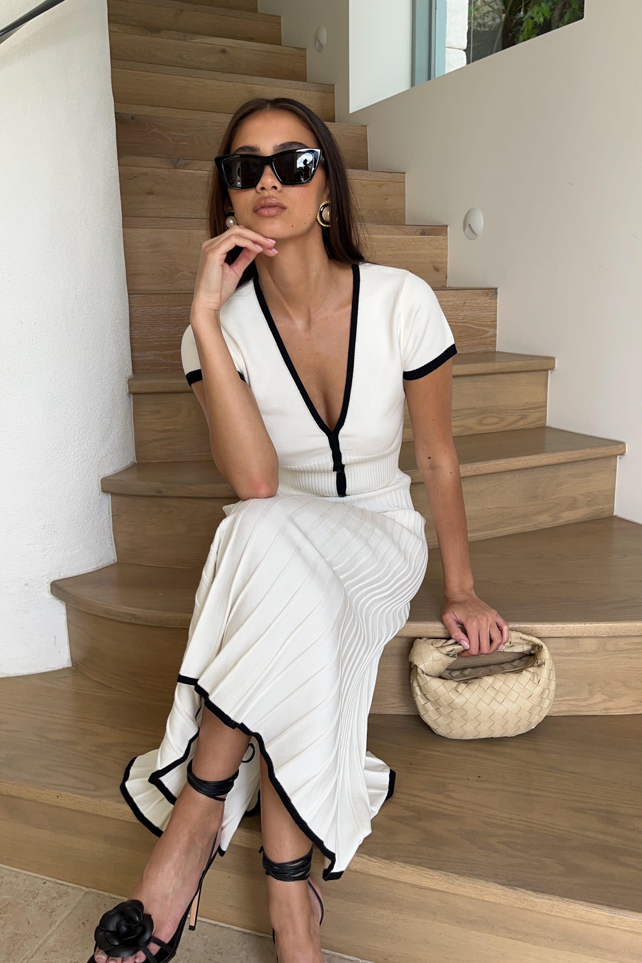 White ribbed crop top and pleated midi skirt set, deep V button front with black trim.