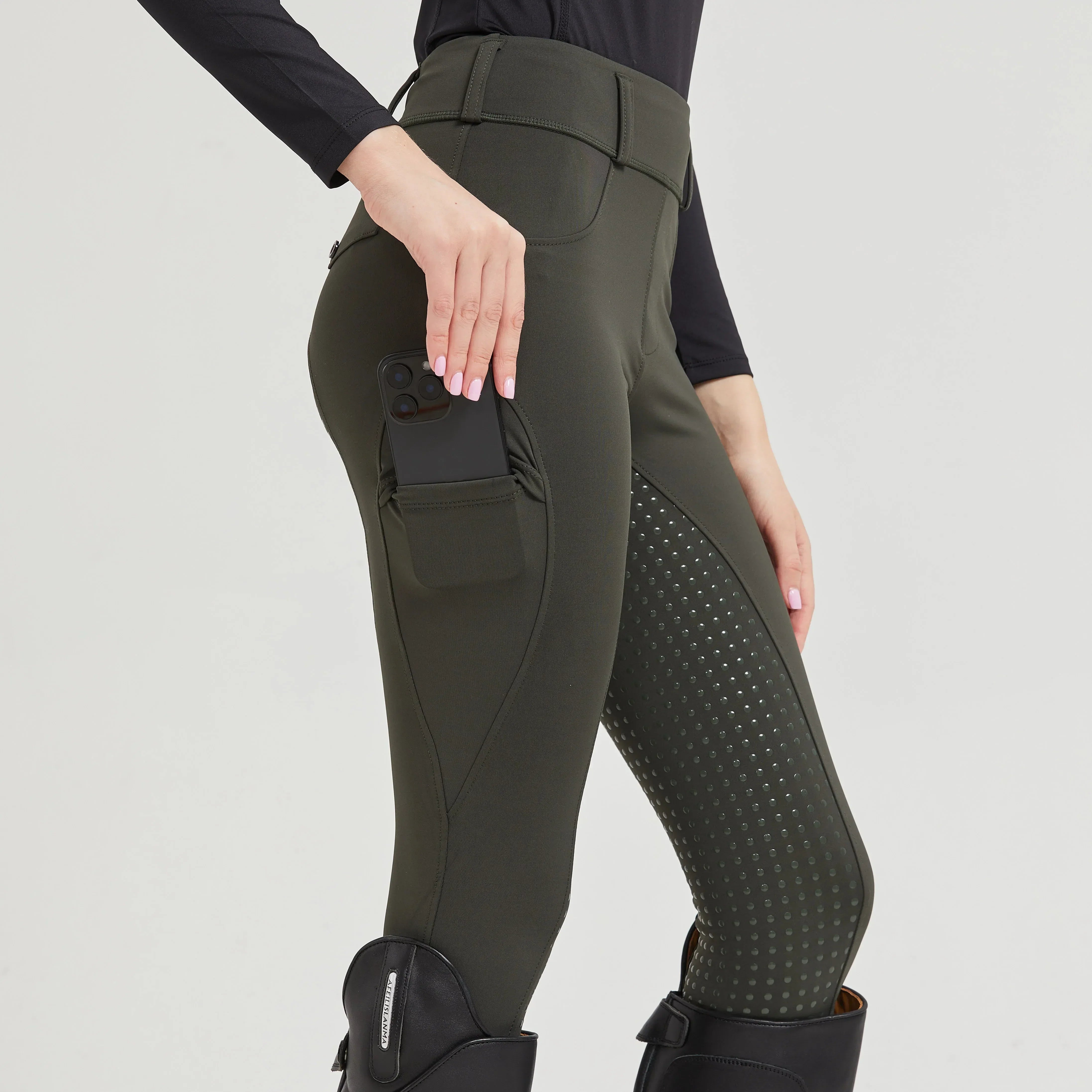 Women’s high-waist riding breeches in olive green with dotted grip panel detail at thigh