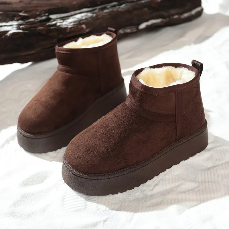 Pair of dark brown suede ankle boots with cream fleece lining and thick soles
