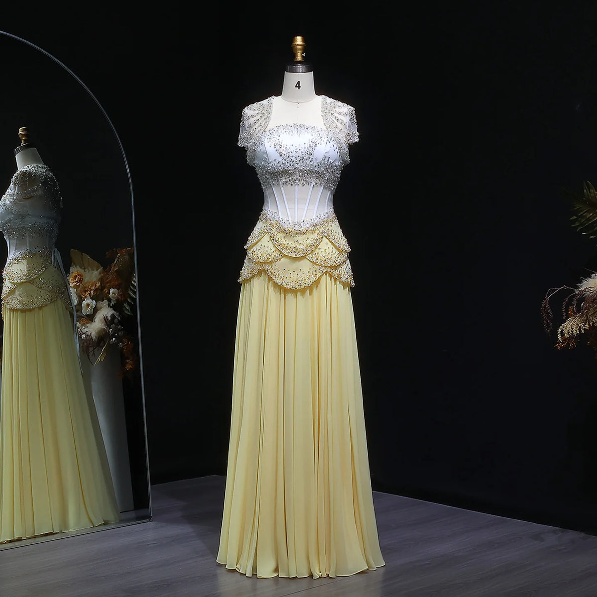 White and pale yellow beaded chiffon evening gown with a corset bodice and short lace sleeves
