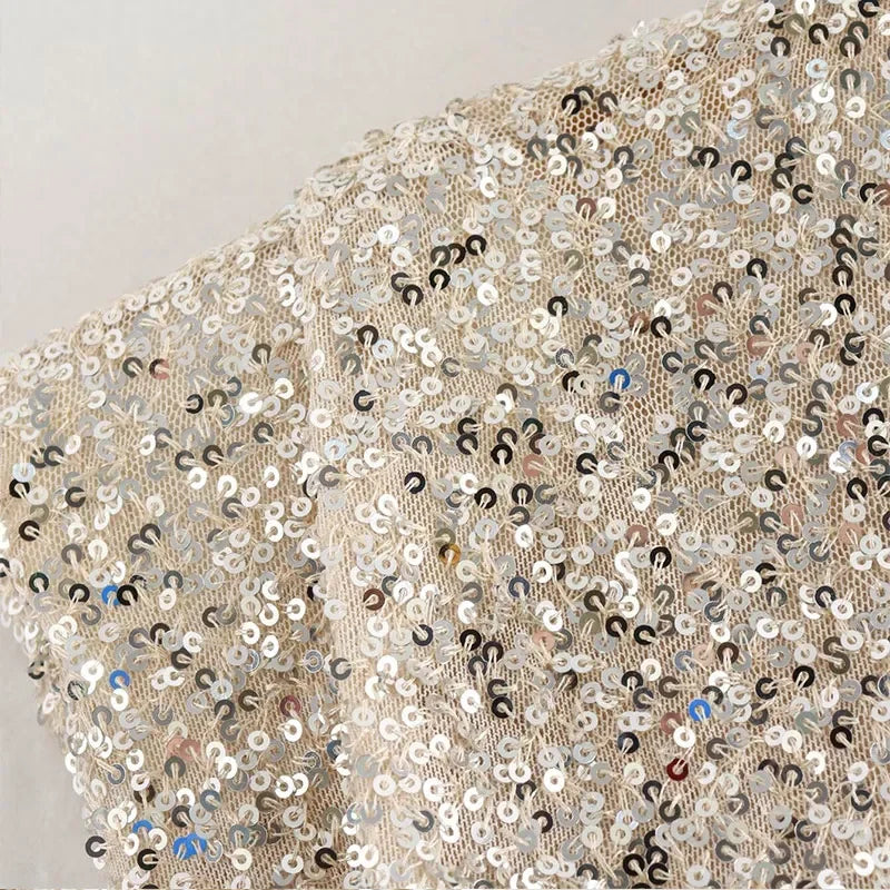 Silver sequin fabric close-up with densely stitched sequins