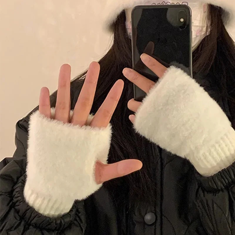 White plush fingerless gloves worn with fingers and thumbs exposed