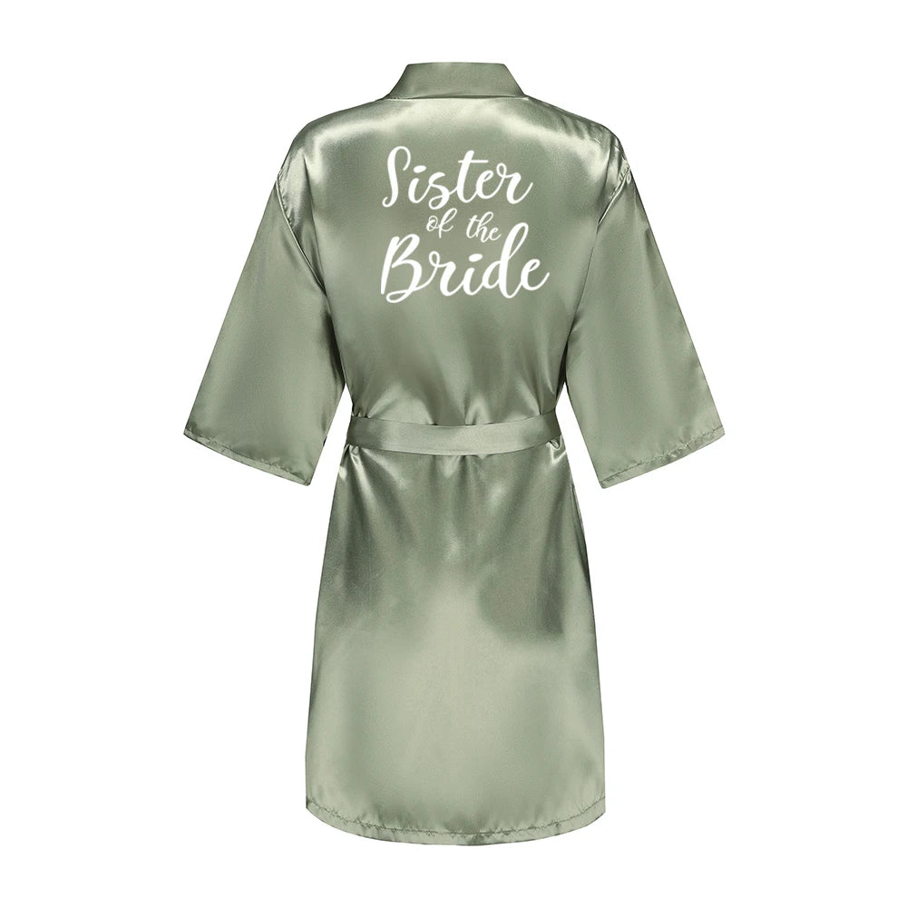 Sage green satin robe with white Sister of the Bride lettering on the back
