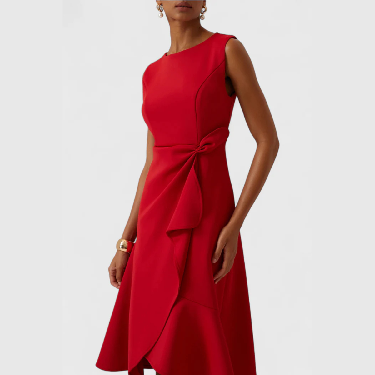 Sleeveless red midi dress with asymmetric ruffle and tied waist detail