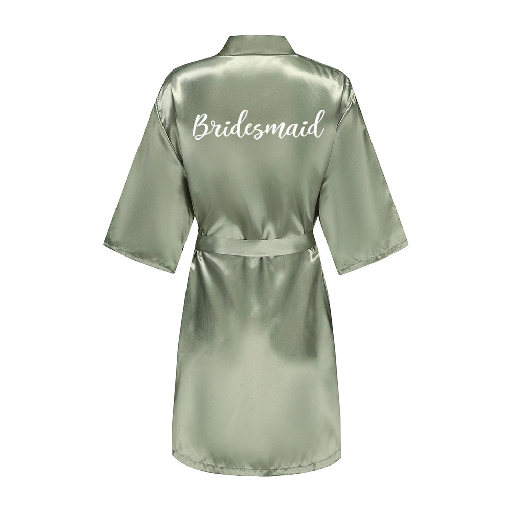 Sage green satin robe with white Bridesmaid lettering across the back