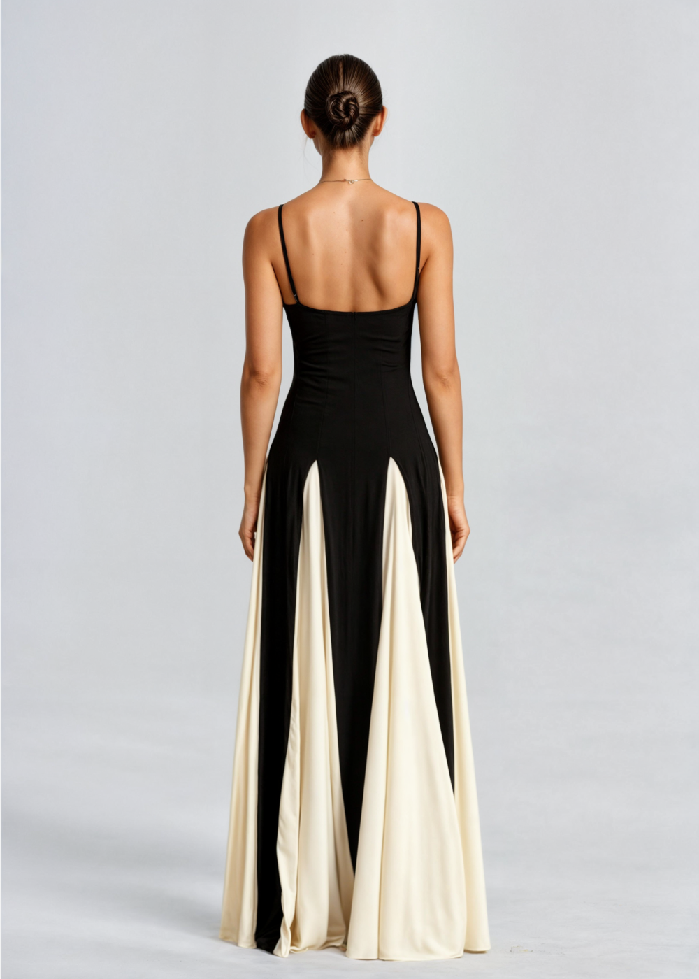 Back view of black satin maxi dress with spaghetti straps and vertical cream panels