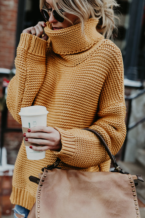 Mustard chunky knit high-neck sweater with long sleeves and ribbed cuffs.