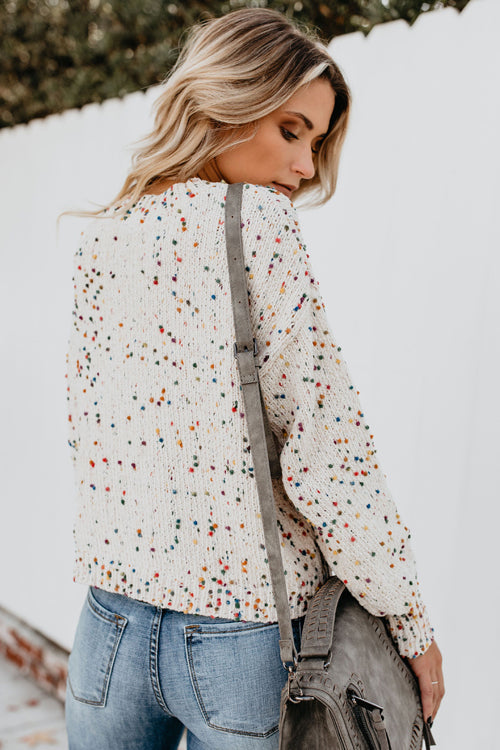 Beige speckled dot knit sweater with crew neck and relaxed fit