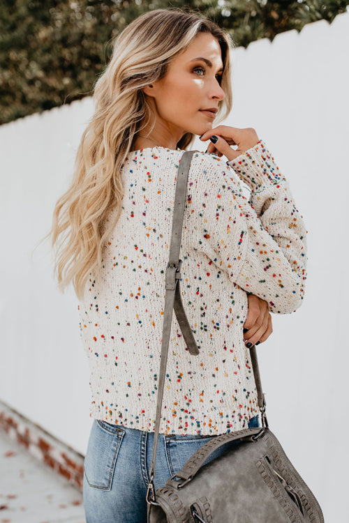 Beige knit sweater with colorful dot speckles and crew neckline