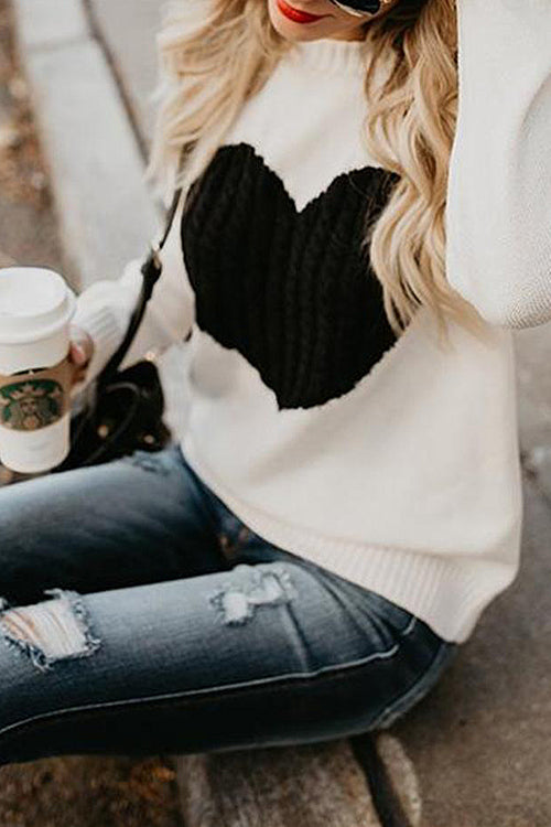 Cream knit sweater with black heart pattern on the front, long sleeves