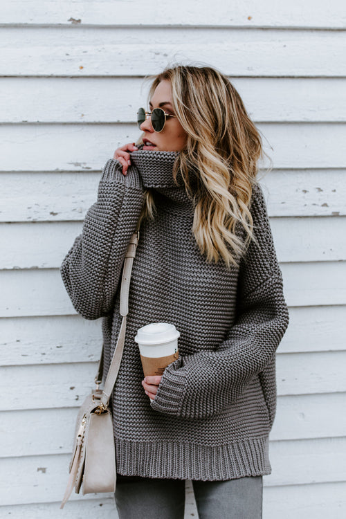 Grey knit high-neck sweater with long sleeves, loose fit.