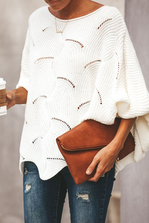 White oversized knit sweater with bat-wing sleeves and arched stitched pattern