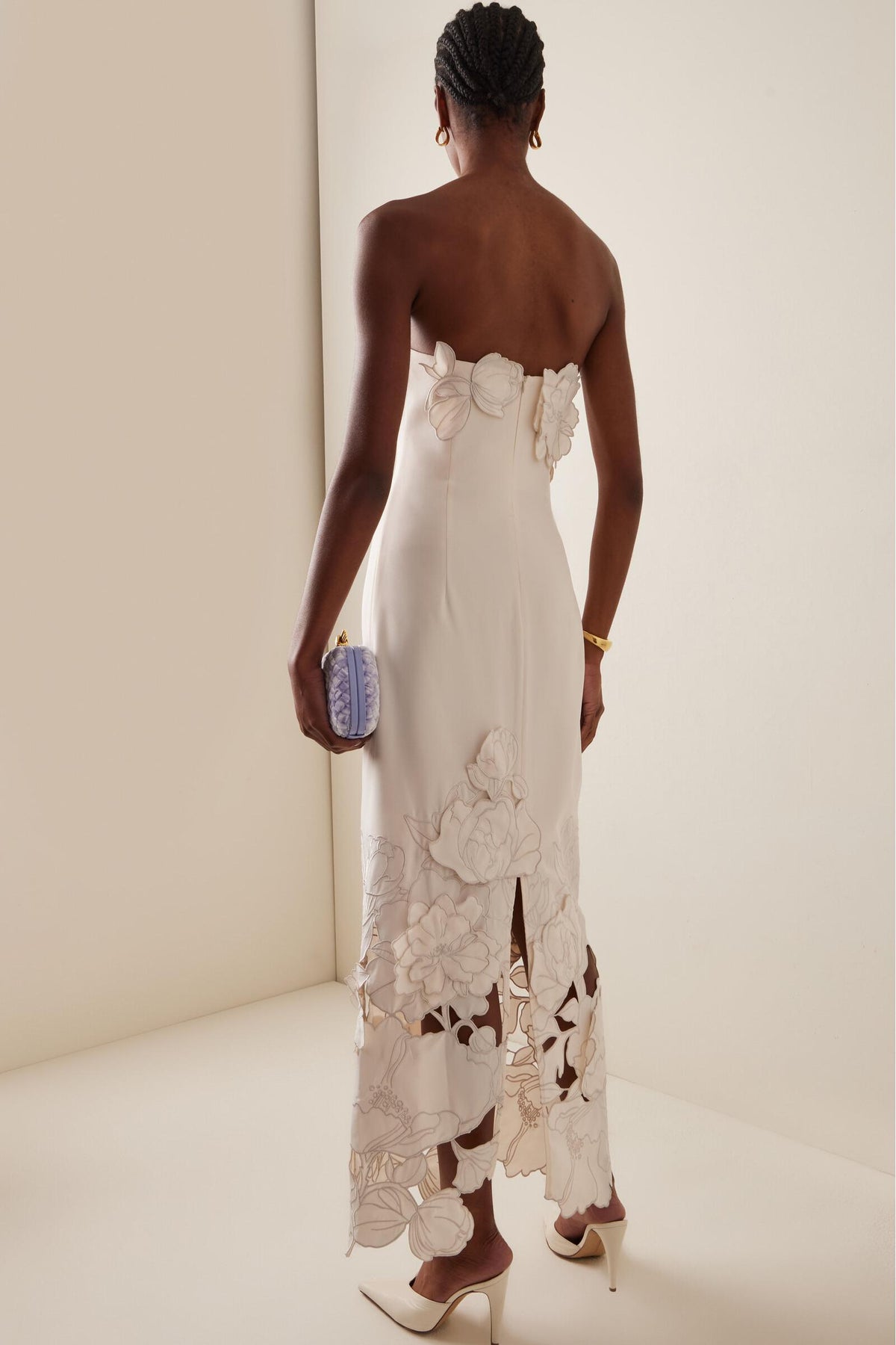 Cream strapless bodycon maxi dress from back with 3D floral appliques and cutout hem