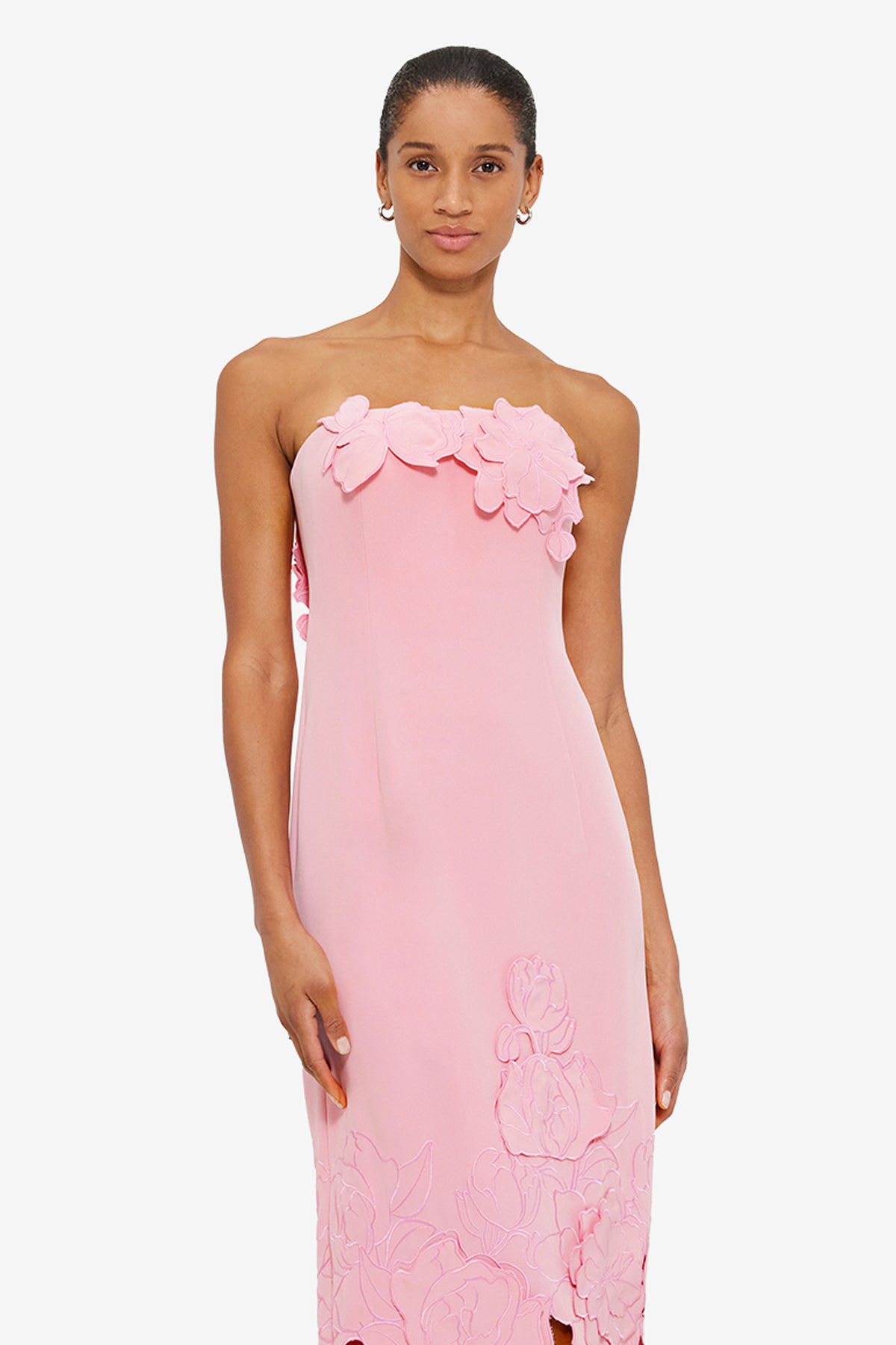 Pink strapless satin bodycon maxi dress with 3D floral appliqué and cutout hem