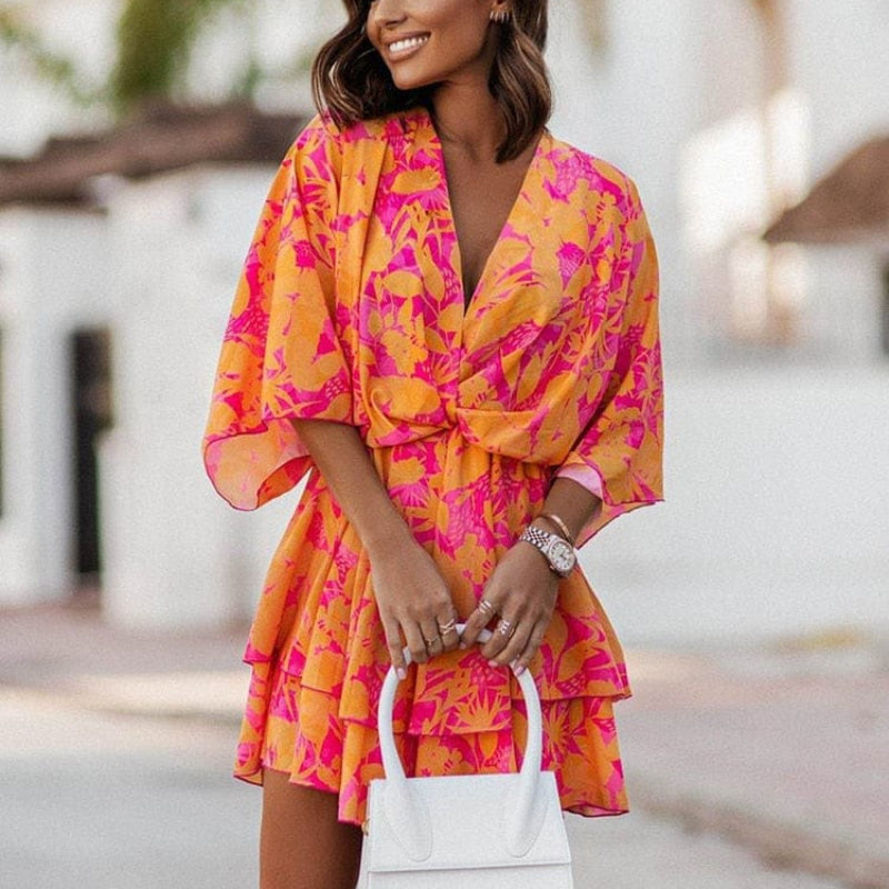Orange floral chiffon V-neck mini dress with flutter sleeves and tiered ruffle skirt