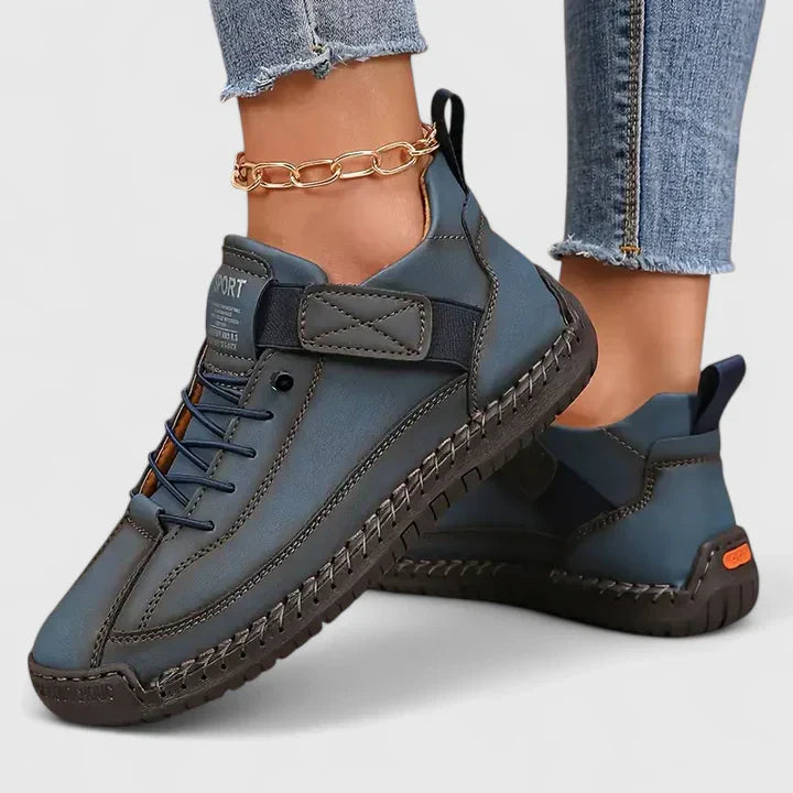Blue faux leather lace-up sneakers with ankle strap and dark rubber sole