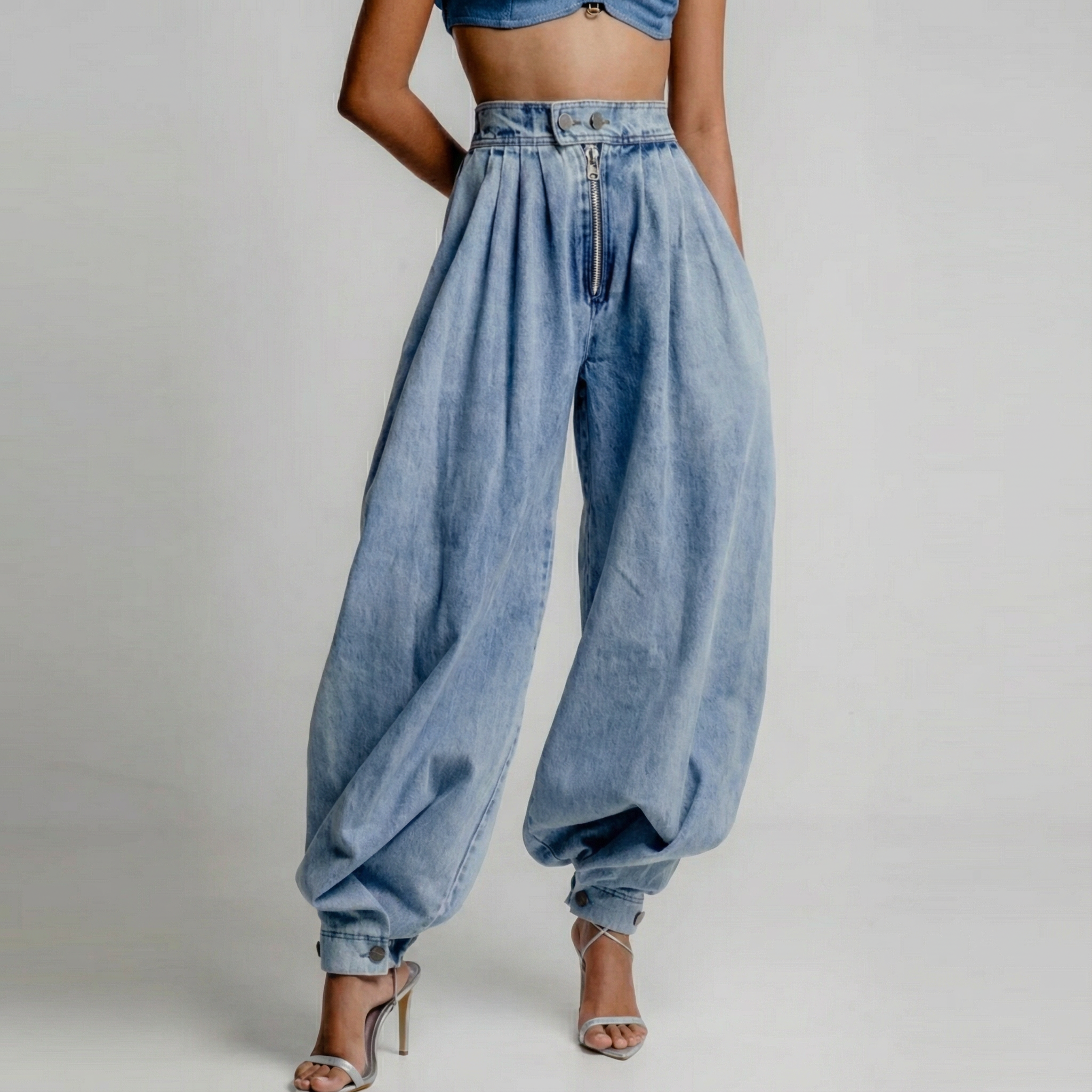 High-waist blue balloon-leg jeans with pleated front and gathered ankle cuffs