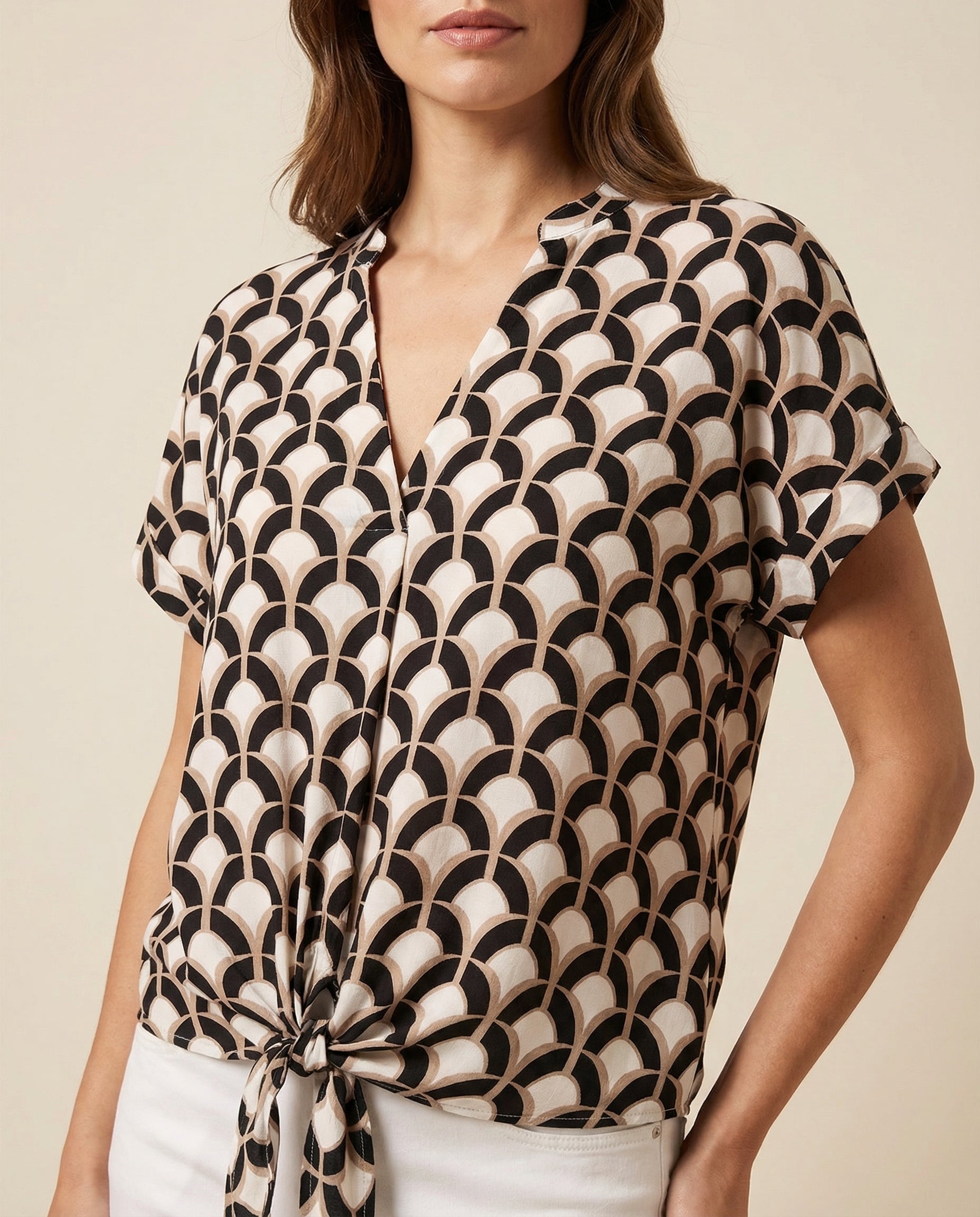 V-neck tie-front blouse with short sleeves, black and cream fan-like geometric print