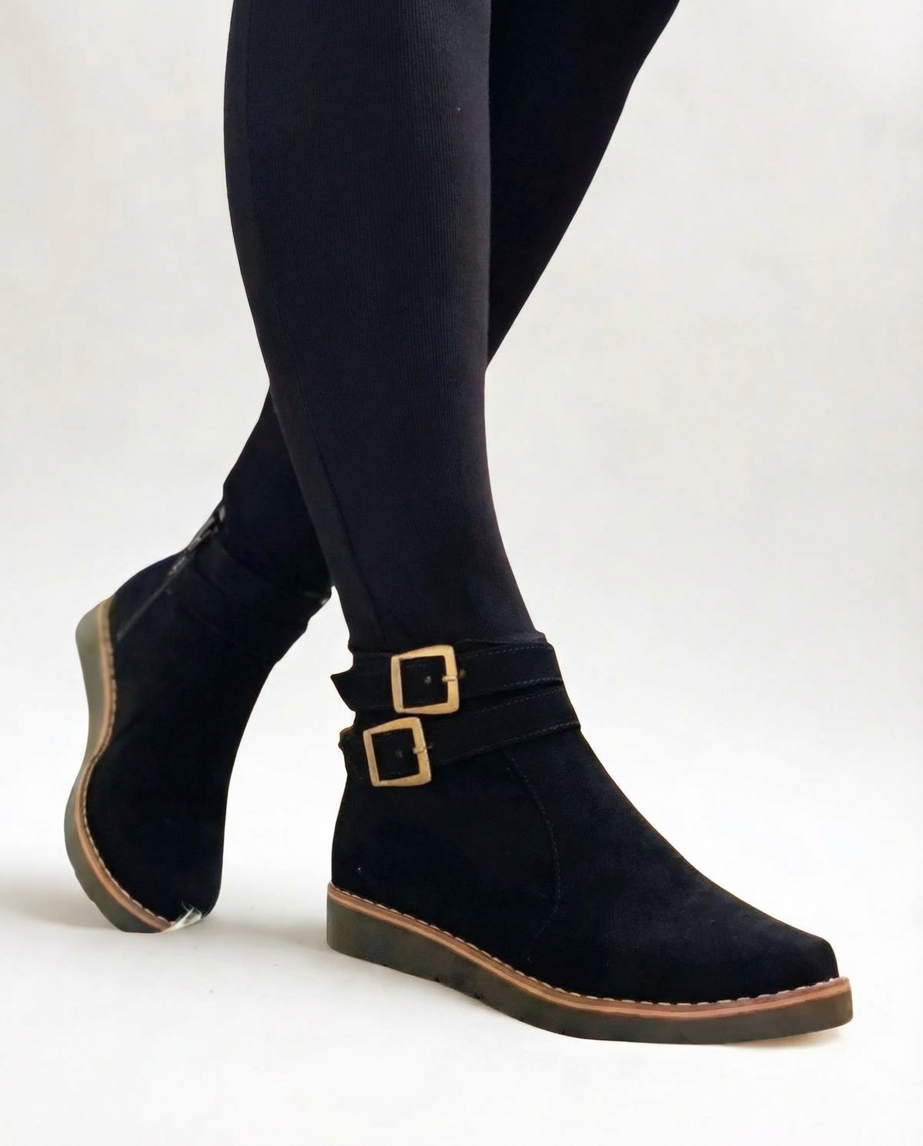 Black suede ankle boots with double buckle strap and flat sole