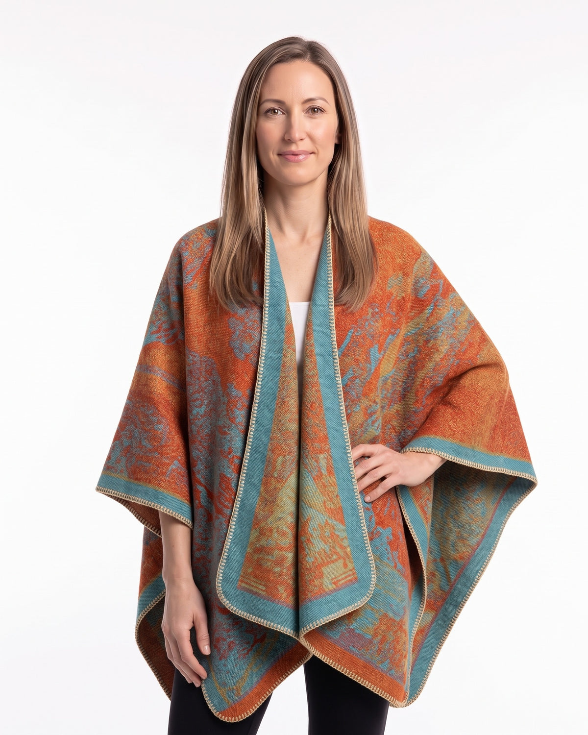 Women’s reversible poncho cape with oversized drape, orange and teal jacquard pattern