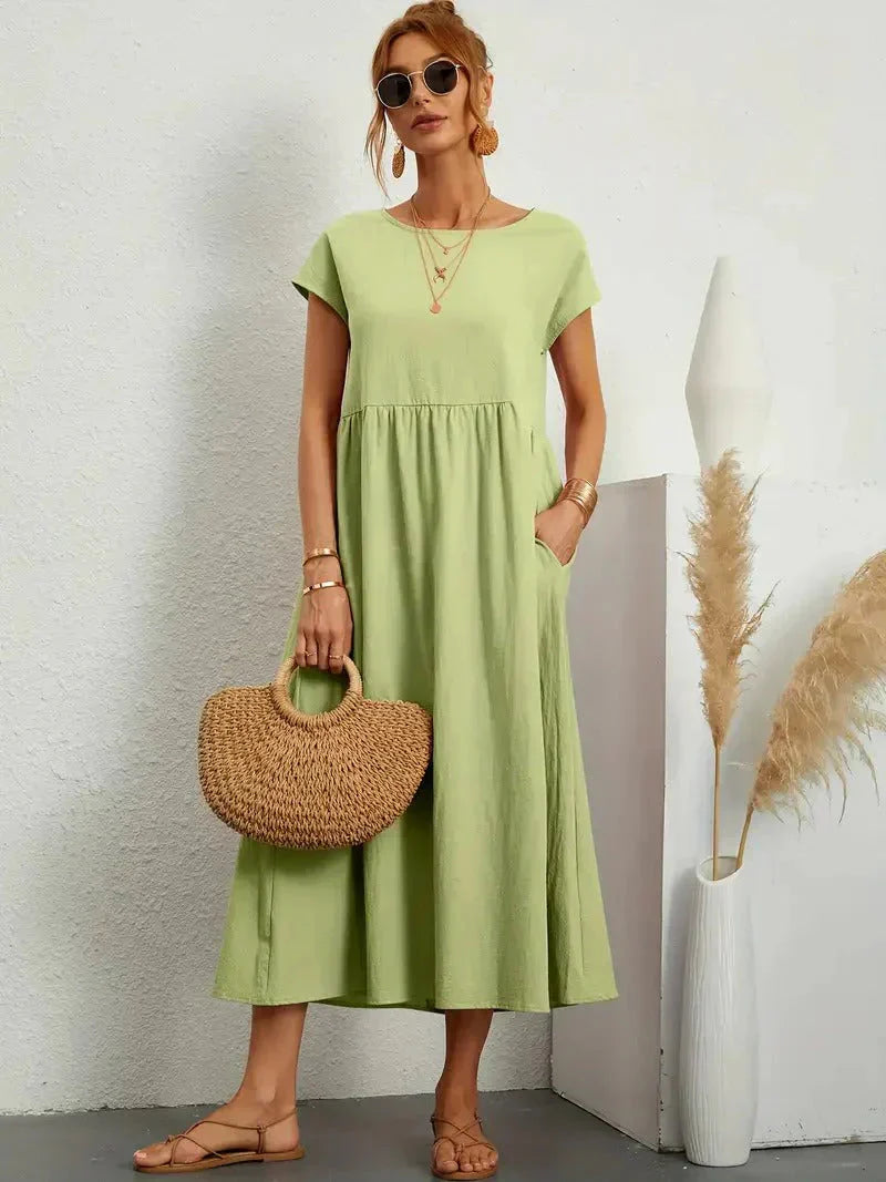 Olive green smocked maxi dress with short cap sleeves and gathered tiered skirt