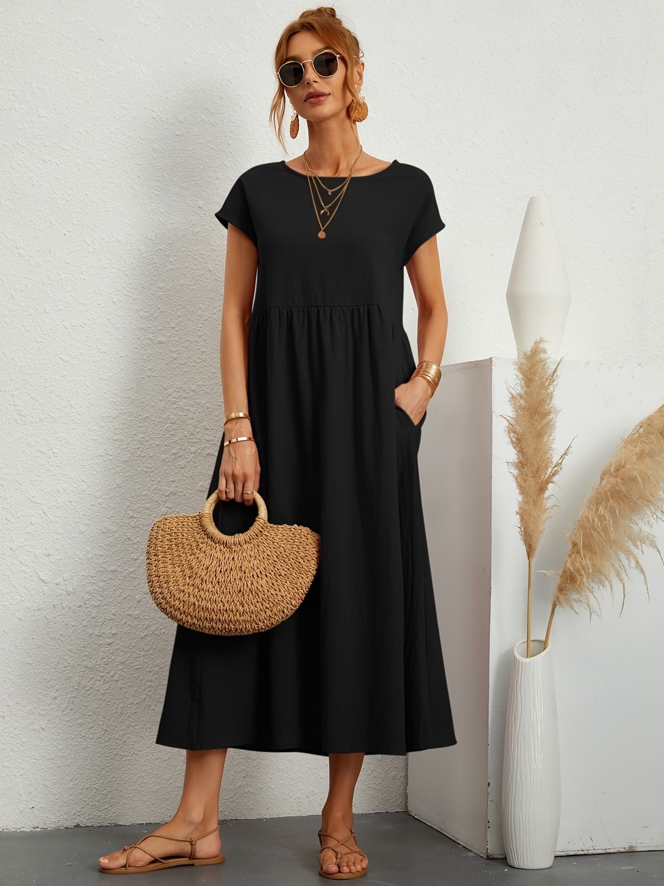 Black maxi dress with gathered smocked bodice and short sleeves, loose A-line