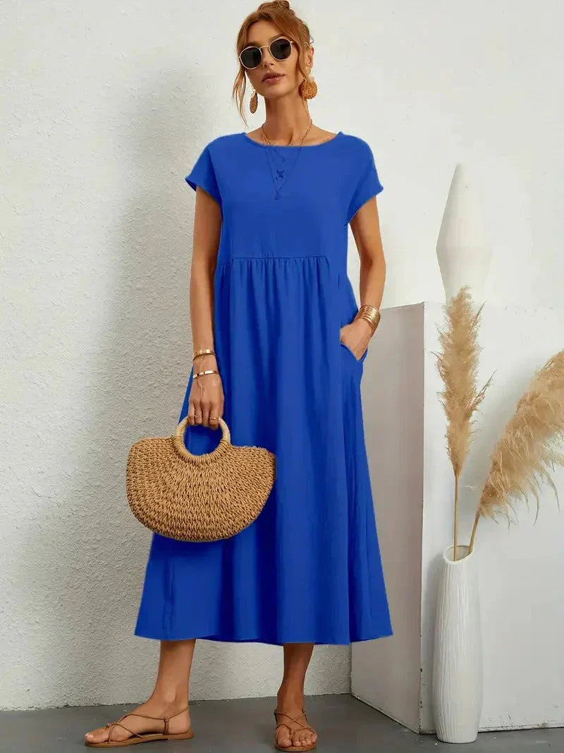 Royal blue maxi dress with gathered smocked bodice and short sleeves, loose A-line