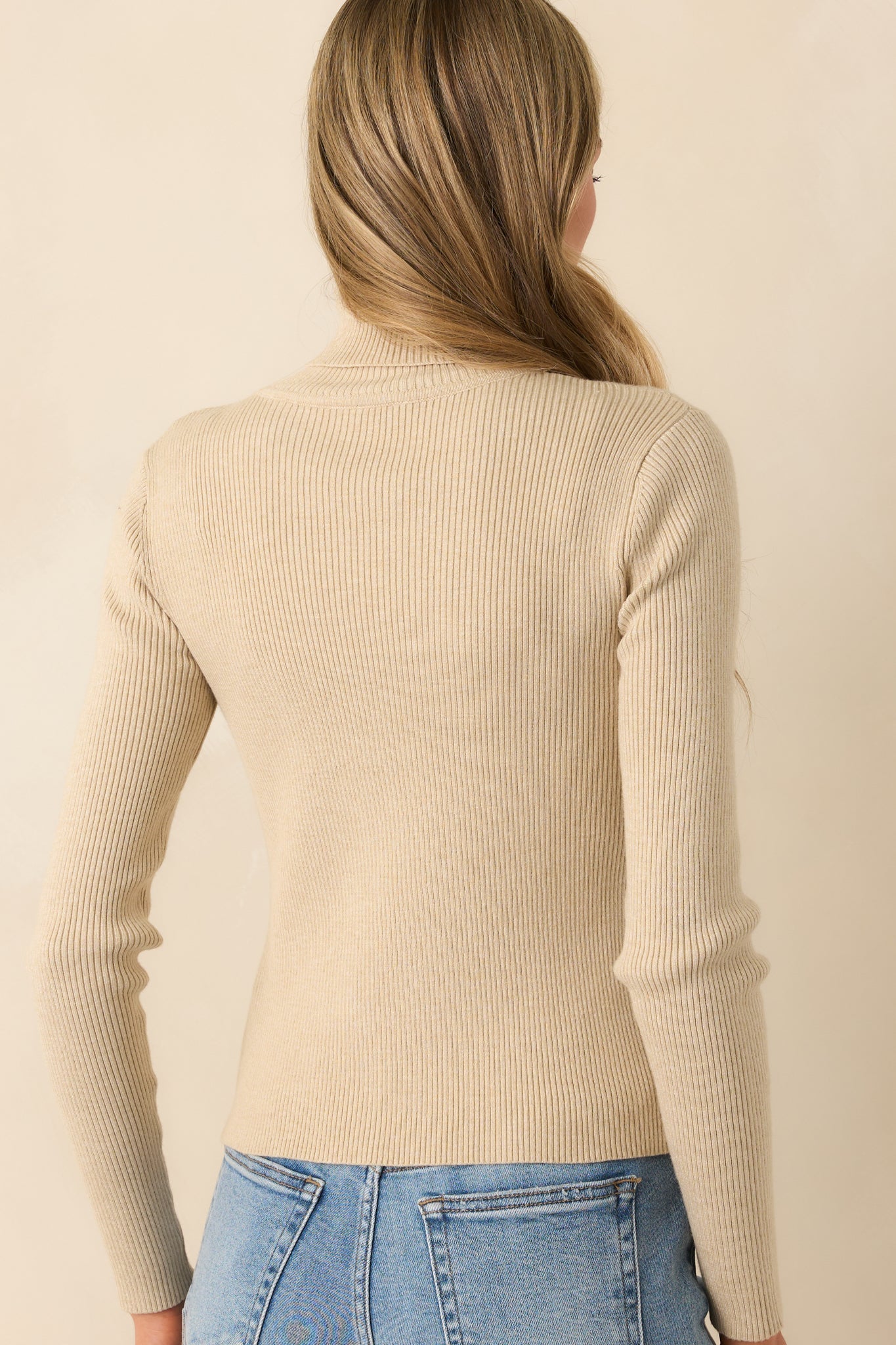 Beige ribbed long-sleeve turtleneck sweater, back view