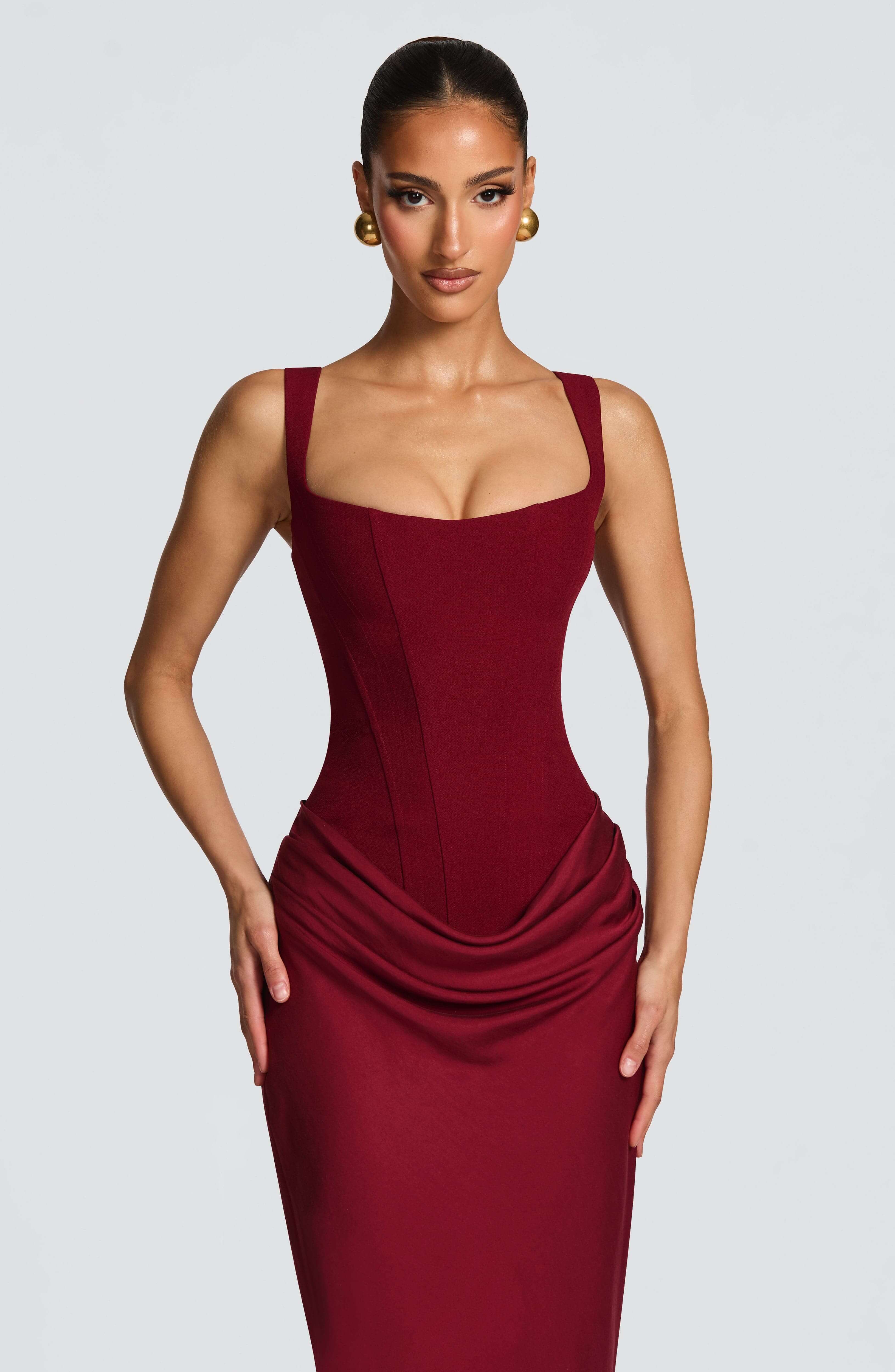 Burgundy sleeveless bodycon maxi dress with square neckline and ruched drape